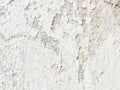 Background, surface texture. a layer of white peeling paint on rough gray concrete, cement, plastered wall. Royalty Free Stock Photo