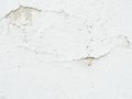 Background, surface texture. a layer of white peeling paint on rough gray concrete, cement, plastered wall. Royalty Free Stock Photo