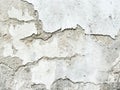 Background, surface texture. a layer of white peeling paint on rough gray concrete, cement, plastered wall. Royalty Free Stock Photo