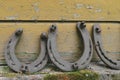 Background surface of very old and rusty horseshoes placed near the wall Royalty Free Stock Photo