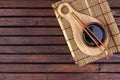 Background for sushi. Bamboo mat, soy sauce, chopsticks on wooden table. Top view and copy space Royalty Free Stock Photo