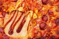 Background of tasty BBQ pizza with ham, bbq sauce, bacon and salami, macro photo, close up view