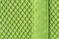 Background of textile mesh over cotton jersey. Macro. Texture of light green knitted fabric with mesh for outerwear casual Royalty Free Stock Photo