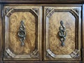 Background texture: antique bedside table with decorative handles. The doors of the old chest of drawers, with patterns. Wooden Royalty Free Stock Photo