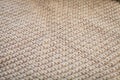 Background texture of beige pattern knitted fabric made of cotton or wool closeup. Royalty Free Stock Photo