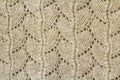 Background texture of beige pattern knitted fabric made of cotton or wool closeup Royalty Free Stock Photo