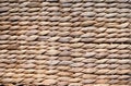 Background texture of beige or straw colored wicker or seagrass