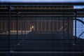 Background or texture in the blue sky of a crossbeam from building lattices. View of balconies from below. Cage, grid, wire.