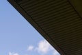 Background or texture in the blue sky of a crossbeam from building lattices. View of balconies from below. Cage, grid, wire.