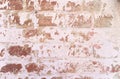 Background texture of a brick wall with old white crumbling paint.