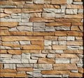 Background and texture. Brown and gray wall made of embossed natural stones blocks Royalty Free Stock Photo