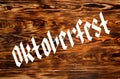 Texture from burned brown pine wood. Oktoberfest inscription. Royalty Free Stock Photo