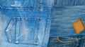 Background texture of denim fabric with pockets and stitched seams with buttons and rivets from different pieces of jeans