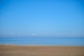 The background texture desert beach. A cloudless sky and sand