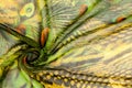 Background texture, drawing. Silk fabric. Light airy fabric. Green with peacock feathers. Yellow shade. Fabric cotton silk