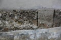 Background, texture. a fragment of an old wall made of rectangular stone blocks on concrete cement masonry.