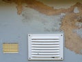 Background texture gray house facade with broken plaster and air ventilation grille Royalty Free Stock Photo