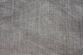 Background and texture of gray linen fabric with close weaving. slightly dented.