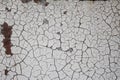 Background texture of gray peeling paint over rusted metal, crackled pattern