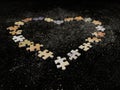Background texture: heart shape on puzzle paper background. Puzzle in the details in the form of a mosaic. Concept: love, Royalty Free Stock Photo