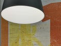 Background texture: lamp on a background of yellow-orange wall. Spotlight on a painted brick wall. Concept: interior lighting, Royalty Free Stock Photo