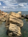 Background texture: large stones of various shapes in the sea. A pile of granite boulders against the background of the sea and