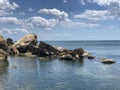 Background texture: large stones of various shapes in the sea. A pile of granite boulders against the background of the sea and Royalty Free Stock Photo