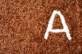 Vitamin A written in flax seed back ground. healthy diet. background with texture made of of brown flax seeds