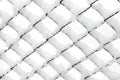 Background texture made of rabitz grid covered with snow. Royalty Free Stock Photo