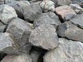 Background texture: many large stones of different shapes. A pile of granite boulders. Concept - stone, hardness, foundation