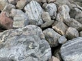 Background texture: many large stones of different shapes. A pile of granite boulders. Concept - stone, hardness, foundation