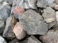 Background texture: many large stones of different shapes. A pile of granite boulders. Concept - stone, hardness, foundation