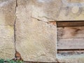 Background texture old broken plastered stone wall and wooden boards Royalty Free Stock Photo