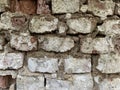 Background texture: old, damaged red brick wall. Shabby building facade with damaged stucco Royalty Free Stock Photo