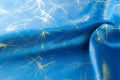 Background texture, pattern. Fabric blue silk with gold pattern. Royalty Free Stock Photo