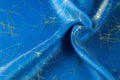 Background texture, pattern. Fabric blue silk with gold pattern. Royalty Free Stock Photo