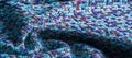 Background texture, pattern. Winter fabric, warm. big braided thread. Blue-red yellow threads. This photo will make your design