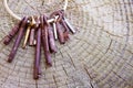 A ring of antique keys resting on a tree stump;