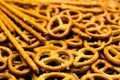 Background texture of salted salty pretzels and mini sticks in the traditional form of the hinge assembly