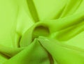 Background texture of silk fabric. This is a natural green salad scarf, this beautiful nylon satin made of artificial silk with a Royalty Free Stock Photo