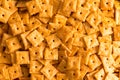 Background texture of square cheese crackers Royalty Free Stock Photo