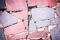 Background with a texture of a stone mosaic. Large red and gray fragments of granite are chaotically laid out. Beautiful