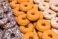 Background texture: sweet dessert. Delicious pastries on the shelf of a candy store. Donuts with holes inside. Baked