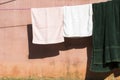Background texture terry cloth on washing line dry in the sun beside cement walls