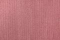 The background of textured pale pink natural fabric.