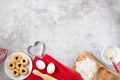 Background on the theme of Valentine`s Day. Kitchen utensils and heart-shaped biscuit baking products are on the underside of the Royalty Free Stock Photo