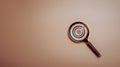 On the background, there is a target board icon inside a magnifying glass. the idea of leading to a goal Learn to plan, achieve