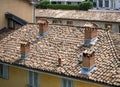 Background with tiled roofs and brick chimneys. Buildings stand parallel to each other. Royalty Free Stock Photo