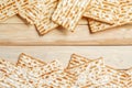 Background for the traditional Jewish holiday Pesach. Passover matzo bread on a wooden table. Matzoh frame. Place for your text Royalty Free Stock Photo