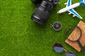 Background for travel and vacation. Weekend, summer mood. Airplane, passport, compass. Green grass for background